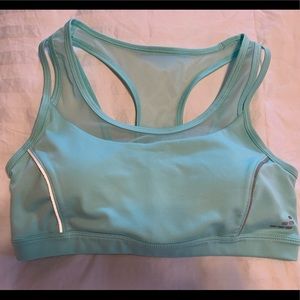 Turquoise sports top by BCG. Size M. Removable inserts. Mesh accents.